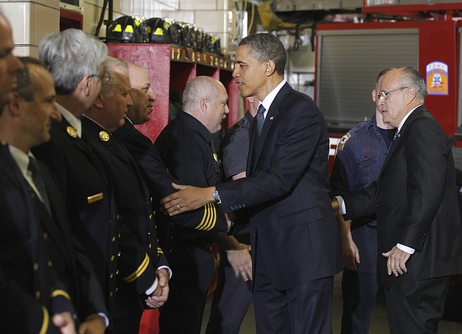 President Barack Obama and former New York City Mayor Rudy Giuliani, right, meet with firefighters and first responders at Engine 54, Ladder 4, Battalion 9 before visiting the National Sept. 11 Memorial at Ground Zero in New York, Thursday, May 5, 2011. (AP Photo/Charles Dharapak)