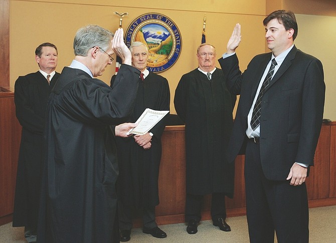 Jim Grant/Nevada AppealTom Armstrong is sworn in as the new Justice of the Peace by Judge John Tatro on Monday morning. Attending the ceremony are, from left, Judge James Wilson, Jr., Judge James Todd Russell and Judge Steven McMorris.