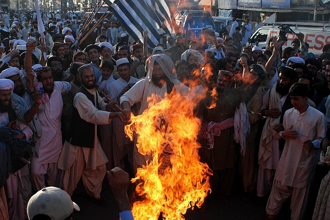 Angry supporters of Pakistani religious party Jamiat Ulema-e-Islam burn representation of the United States during a rally to condemn the killing of Osama bin Laden in Quetta, Pakistan on Monday, May 2, 2011.  al-Qaida chief  Osama bin Laden was slain in his hideout in Pakistan early Monday in a firefight with U.S. forces, ending a manhunt that spanned a decade. (AP Photo/Arshad Butt)(AP Photo/Arshad Butt)