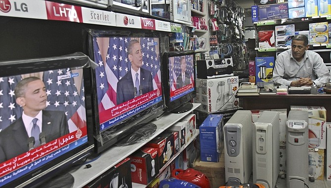 A Palestinian watches the speech of US President Barack Obama on television at a store in Gaza City, Thursday, May 19, 2011. Trying to advance debate in the explosive Middle East, President Barack Obama on Thursday endorsed a key Palestinian demand for the borders of its future state and prodded Israel to accept that it can never have a truly peaceful nation that is based on &quot;permanent occupation.&quot; Obama&#039;s urging that a Palestinian state be based on 1967 borders - those that existed before the Six Day War in which Israel occupied East Jerusalem, the West Bank and Gaza - was a significant shift in U.S. policy and seemed certain to anger Israel. (AP Photo /Adel Hana)