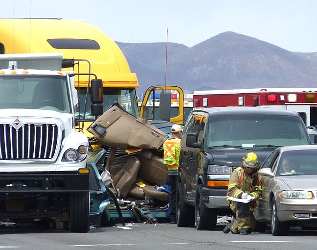 Kurt HildebrandFirefighters work at the scene of a seven-car pileup at Jacks Valley Road and Highway 395.