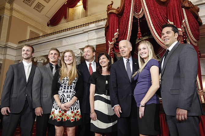 From left, Harrison Heller, Andrew Heller, Hilary Heller, Sen. Dean Heller, R-Nev., Lynne Heller, Vice President Joe Biden,  Emily Ableser, and Edward Ableser, pose for a photographer in the Old Senate Chambers on Capitol Hill in Washington, Monday, May 9, 2011, after a mock swearing in ceremony for Heller. (AP Photo/Alex Brandon)