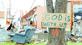 Debris is scattered over a yard on  Friday morning, May 27, 2011, in Joplin, Mo.  At least 126 people were killed and hundreds more injured when a tornado cut a destructive path through Joplin on Sunday evening. (AP Photo/The Joplin Globe, T. Rob Brown)