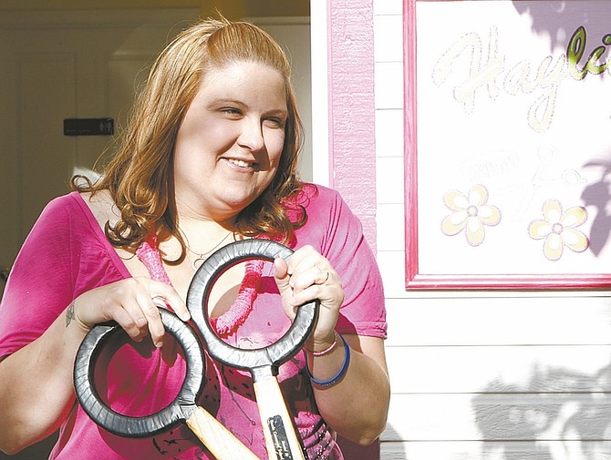 Shannon Litz/Nevada AppealHaylie Hume cuts the ribbon at the grand opening of her salon, Haylie&#039;s Hair Hut, on Thursday.
