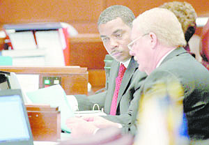 Nevada Senate Majority Leader Steven Horsford, D-North Las Vegas, left, talks with Sen. Mike Schneider, D-Las Vegas, on the Senate floor Wednesday, May 25, 2011, at the Legislature in Carson City, Nev. Earlier Wednesday Horsford expressed concerns over the plan to transfer more funding responsibility for youth parole and child protective services to the counties.  (AP Photo/Cathleen Allison)