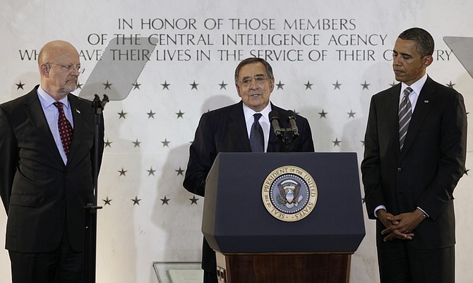 President Barack Obama, right, and Director of National Intelligence James Clapper, left, flank Central Intelligence Agency (CIA) Director Leon Panetta as he speaks to CIA employees at the CIA Headquarters, Friday, May 20, 2011 in Langley, Va. Obama congratulated the country&#039;s intelligence workers for the years of effort that led to the discovery and killing of terrorist Osama bin Laden, and their daily work in protecting America. He said he&#039;d never felt prouder or more confident about them, and told them they&#039;re proof that when Americans put their mind to something, &quot;there is nothing we cannot do.&quot; (AP Photo/Carolyn Kaster)