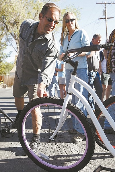 Shannon Litz/Nevada AppealMike Malley and Linda King, both of Carson City, check out one of the bikes in a raffle at the Bike to Work Week party on Friday at the Firkin &amp; Fox.