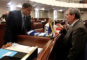 Senate Majority Leader Steven Horsford, D-North Las Vegas, and Minority Leader Mike McGinness, R-Fallon, talk on the Senate floor Monday, May 30, 2011, at the Legislature in Carson City, Nev. Lawmakers continue to work with the governor on the state budget, including talks to extend $679 million worth of taxes that were set to expire Jun 30. (AP Photo/Cathleen Allison)