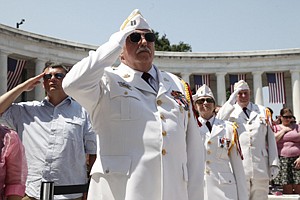 Veterans of Foreign Wars honor guards salute during the playing of &quot;Taps&quot; as President Barack Obama participates in the Memorial Day ceremony at Arlington National Cemetery Monday, May 30, 2011. (AP Photo/Charles Dharapak)