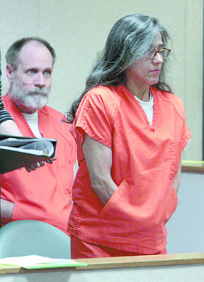 Nancy Garrido takes a seat as her husband, Phillip Garrido, background, looks on before the start of their sentencing hearing for the 1991 kidnapping of Jaycee Dugard, at the El Dorado County Superior Court in Placerville,  Calif., Thursday, June 2, 2011. Judge Douglas C. Phimister sentenced Phillip Garrido to 431 years to life  and Nancy Garrido to 36 years to life in state prison.(AP Photo/Rich Pedroncelli, Pool)