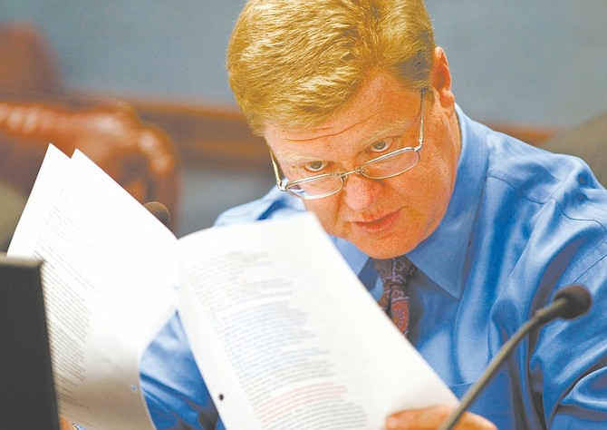 Published Caption: Sen. Mark Amodei, R-Carson City, studies language of the bill that softened the the 2006 Nevada Clean indoor Air Act during the Legislature in April. However, the American Cancer Society has petitioned Carson District Court to declare the legislation unconstitutional.
