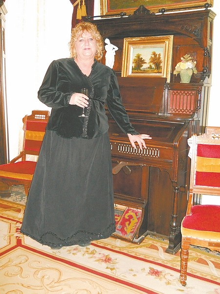 Host pychic medium Janet Jones poses at a champagne reception in the formal parlor of the Mackay Mansion in Virginia City.