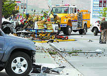 Shannon Litz/Nevada AppealFirefighters remove the roof from a pickup truck involved in an accident on Thursday afternoon near the Frontier Plaza.