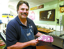 Shannon LItz/Nevada AppealButler Meats owner David Theiss shows a roast Thursday. The butcher shop, which sells natural meats,  has been a Carson City mainstay since 1973.