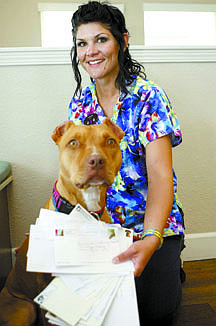 Shannon Litz/Nevada Appeal News ServiceAubrie Ricketts shows some of the envelops that contained donations to help pay for surgery for Ruby the pit bull.