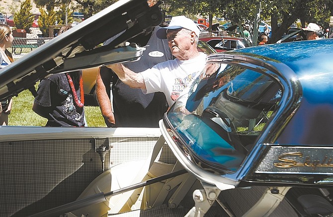 Photos by Shannon Litz/Nevada AppealNort Pickett of Carson City talks about his 1957 Ford Fairlane 500 retractable at the Run What Cha Brung car show at Fuji Park on Saturday. The car had the first retractable hardtop roof.