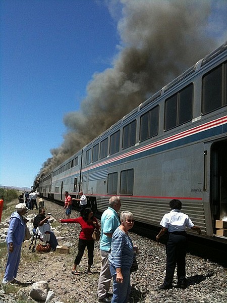 In this photo provided by Ron Almgren.  passengers and Amtrak train staff are seen at the site of a collision between an Amtrak westbound train and a truck on  U.S. 95 about 4 miles south of Interstate 80 on Friday, June 24, 2011, 70 miles east of Reno, Nev. The truck driver and one person on the train were killed said Nevada Highway Patrol Trooper Dan Lopez. An unknown number of other people on the train were injured and were being taken by ambulances to the hospital.  (AP Photo/Ron Almgren)