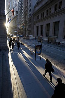 FILE - In this Dec. 22, 2008 file photo, people walk to work on Wall Street in New York. It may come as no surprise to residents of big cities: Living there can be bad for your mental health. Using imaging scans, researchers have found that in city dwellers or people who grew up in urban areas, certain areas of the brain react more vigorously to stress. (AP Photo/Mark Lennihan, File)
