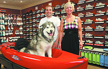 Jim Grant/Nevada AppealCV Sports owner Robyn Bond, right, and general manager Richard Norris pose with Maverick in the sport store&#039;s extensive shoe department.