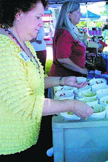 Nevada Appeal file photoValerie Wyman of Soroptimist International of Carson City serves up samples of chili verde from High Sierra Regional Chili Cookoff contestants after the judging last year at Glen Eagles Restaurant. The cookoff is from 11 a.m.-5 p.m. today and Sunday. Soroptimists are raising money for local causes through a raffle and selling tasting kits, water and samples.