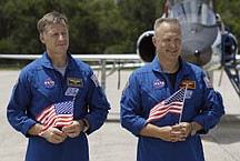STS-135 commander Chris Ferguson, left, and pilot Doug Hurley hold U.S. flags as they listen to mission specialist Sandy Magnus, not shown, speak to the media after arriving at the Kennedy Space Center in Cape Canaveral, Fla., Monday, July 4, 2011.  Atlantis, and her crew of four astronauts, is scheduled to lift off Friday morning on an 12-day mission to the international space station.  The launch will bring an end to the shuttle program. (AP Photo/Chris O&#039;Meara)