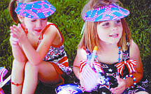 CourtesyEmmy Webb and Londyn Engels take a break after marching in the annual July 4 parade at Kinderland Nursery School.
