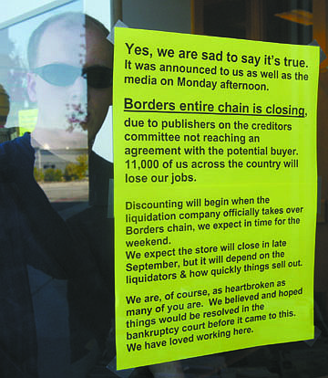 A notice is posted on the front door of Borders to inform customers of their pending closure.