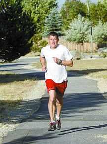 Shannon Litz/Nevada AppealSean Lehmann run behind his house on Thursday evening.