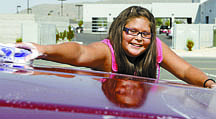 Shannon Litz/Nevada AppealEleven-year-old Brianna Racine washes a truck at the Carson Colony gym on Thursday afternoon during the fundraiser car wash. Members of the Carson Colony Youth Recreation Program raised money for a tribal council member who lost her home to a fire Sunday.