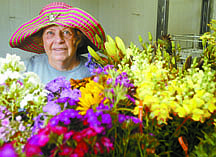 Shannon Litz/Nevada AppealCarole Smith of Smith &amp; Smith Farms is seen with cut flowers ready for bouquets inside her walk-in cooler on Wednesday.