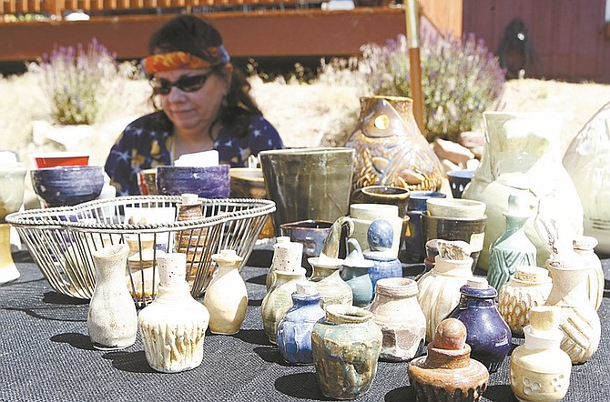 Photos by Shannon Litz/Nevada AppealABOVE: Robin McGregor of Carson City Pottery works on Saturday morning at the Made in Nevada market at Maynard Station in Gold Hill.