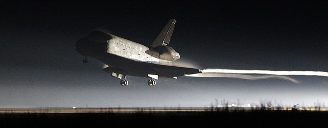 Space shuttle Atlantis lands at the Kennedy Space Center in Cape Canaveral, Fla., Thursday, July 21, 2011.  The landing of Atlantis brings the space shuttle program to an end. (AP Photo/John Raoux)