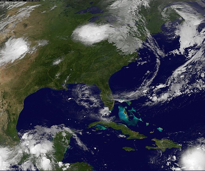 This image provided by NASA taken at 2:32 a.m. EDT Wednesday morning Aug. 3, 2011 shows tropical storm Emily, lower right. Emily brushed past Puerto Rico and set its sights on the Dominican Republic and Haiti, where more than 630,000 people are still without shelter after last year&#039;s earthquake. Forecasters at the National Hurricane Center in Miami said up to 10 inches (25 centimeters) of rain could fall Wednesday in some parts of Haiti and the Dominican Republic, which could cause life-threatening flash floods and mud slides in areas of mountainoust terrain. (AP Photo/NASA)