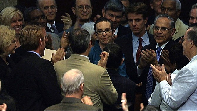 In this image from House Television, Rep. Gabrielle Giffords, D-Ariz., center, appears on the floor of the House of Representatives Monday, Aug. 1, 2011, in Washington. Giffords was on the floor for the first time since her shooting earlier this year, attending a vote on the debt standoff compromise. (AP Photo/House Television)