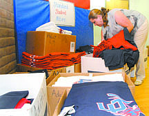Shannon Litz/Nevada AppealMaria Cortez, the vice principal&#039;s secretary at Eagle Valley Middle School, fills a school uniform order on Thursday evening during the back to school boot camp.