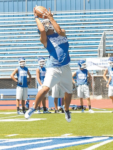 photos by Shannon Litz/Nevada AppealA Carson player makes a catch during the first day of football practice, Thursday.