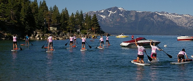 Photos Courtesy Melanie GingellParticipants paddle out for the first leg of the Kaia Paddle Board Triathlon on Aug. 5. Organizers want to make it an annual event.