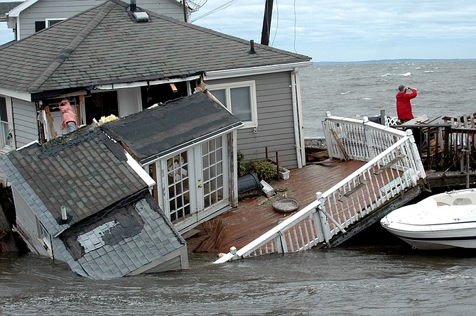 A Fairfield Beach Road home is submerged in Pine Creek in Fairfield, Conn. as treacherous weather caused by Tropical Storm Irene came through the area on Sunday Aug. 28, 2011. Tropical Storm Irene sent sea water flooding into shoreline communities and destroyed oceanfront homes as it surged across Connecticut on Sunday, toppling trees and cutting power to nearly half the state. (AP Photo/The Connecticut Post, Cathy Zuraw)