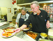 Jim Grant/Nevada AppealFISH family dining room chef Jimbo Cox and volunteer Linda Rae Howard prepare meals for clients on Tuesday.
