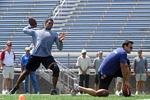 Former Ohio State quarterback Terrelle Pryor works out for NFL football scouts while his agent, Drew Rosenhaus, right, watches at Hempfield Area High School on Saturday, AUg. 20, 2011, near Hempfield, Pa. (AP Photo/Tribune-Review, Erc Schmadel)  PITTSBURGH POST-GAZETTE OUT, UNIONTOWN HERALD STANDARD OUT