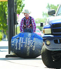 Jim Grant/Nevada AppealMarvin Nash rolls a 140-pound rodeo barrel down North Carson Street to promote anti-bullying on Monday.