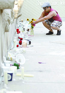 Shannon Litz/Nevada AppealAlbert Atwell of Carson City arranges flowers from his garden at the Nevada State Veterans Memorial on the capitol grounds on Wednesday afternoon.