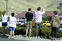 Shannon Litz/Nevada AppealOnlookers watch from the JCPenney parking lot as emergency personnel attend the crime scene Tuesday morning.