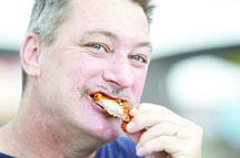 Shannon Litz/Nevada AppealClarence Cunha of Carson City samples chicken wings from Carson City Barbecue on Friday.