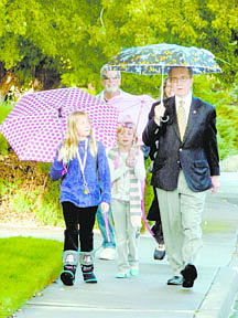 Teri Vance/Nevada AppealMayor Bob Crowell walks Brooke Gudmundson, 8, left, and Riley Gudmundson, 7, to Fritsch Elementary School on Wednesday as part of International Walk to School Day. Following behind is the Gudmundsons&#039; mother, Amber Little, and grandfather Jim Atkins.