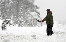Peter Nelson shovels snow from the driveway of a home he is helping remodel near Soda Springs, Calif., Wednesday, Oct. 5, 2011. An early October storm swept through Northern California bringing rain to the lower levels and up to six inches of snow to the Sierra Nevada. (AP Photo/Rich Pedroncelli)