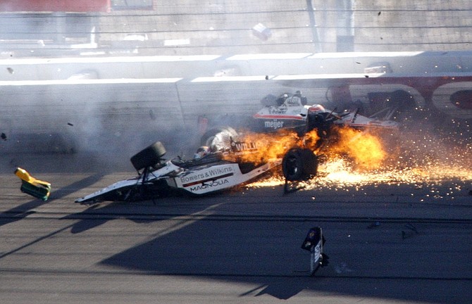 Drivers Dan Wheldon, front, and Will Power crash during a wreck that involved 15 cars during the IndyCar Series&#039; auto race at Las Vegas Motor Speedway in Las Vegas on Sunday, Oct. 16, 2011. Wheldon died following the crash. (AP Photo/Las Vegas Review-Journal, Jessica Ebelhar) LAS VEGAS SUN OUT  MANDATORY CREDIT NO SALES