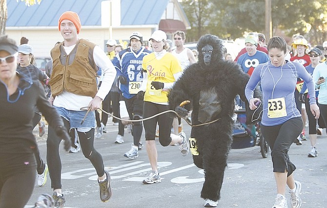 Shannon Litz/Nevada Appeal RIGHT: Craig Kenison and Erick Studenicka, dressed as a gorilla, run in the Nevada Day Classic on Saturday morning.