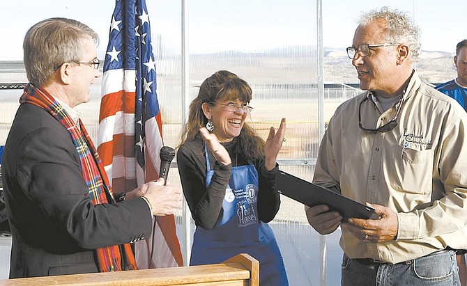 Shannon Litz/Nevada AppealCarson City Mayor Bob Crowell and Greenhouse Project President Karen Abowd present Mark Lopiccolo with a commendation at The Greenhouse Project ribbon cutting on Friday afternoon.
