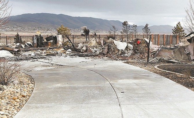 Shannon Litz/Nevada AppealDebris is scattered along a driveway leading to a home that was destroyed in Old Washoe Estates in Pleasant Valley Thursday afternoon.